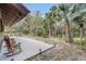 Relaxing backyard patio area featuring rocking chairs and views of the backyard at 255 Butterfly Forest Rd, Geneva, FL 32732