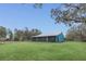 Exterior view of the residence showcasing the manicured lawn and screen porch at 255 Butterfly Forest Rd, Geneva, FL 32732