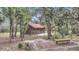 Charming home featuring a red roof, complemented by a cozy outdoor patio with rocking chairs at 255 Butterfly Forest Rd, Geneva, FL 32732