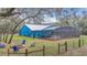 Landscaped yard boasts a fire pit and seating area, perfect for outdoor enjoyment at 255 Butterfly Forest Rd, Geneva, FL 32732