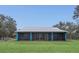Home exterior featuring a spacious screened-in porch and a well-maintained lawn at 255 Butterfly Forest Rd, Geneva, FL 32732