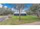 Well-maintained home with metal roof surrounded by a fenced yard and mature trees at 255 Butterfly Forest Rd, Geneva, FL 32732