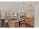 Open-concept kitchen and living area with vaulted ceilings and updated lighting fixtures at 255 Butterfly Forest Rd, Geneva, FL 32732
