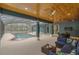 Screened lanai with stylish seating area overlooking a refreshing swimming pool and lush surroundings at 255 Butterfly Forest Rd, Geneva, FL 32732