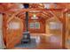 Cozy living area with a wood-burning stove, natural wood paneling, and exposed beams at 255 Butterfly Forest Rd, Geneva, FL 32732