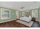 Serene main bedroom featuring wood floors, recessed lighting, and a view of the yard at 255 Butterfly Forest Rd, Geneva, FL 32732