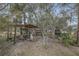 Outdoor cooking area with sink and storage surrounded by mature trees and landscaping at 255 Butterfly Forest Rd, Geneva, FL 32732