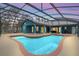 Stunning private pool area features a large screened-in enclosure and spacious lounging areas at 255 Butterfly Forest Rd, Geneva, FL 32732