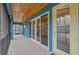 Covered porch with tongue and groove ceiling, access to door, and view to yard at 255 Butterfly Forest Rd, Geneva, FL 32732