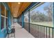 Relaxing covered porch with screened enclosure and view of lush landscaping at 255 Butterfly Forest Rd, Geneva, FL 32732
