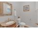 Stylish half bath featuring a decorative mirror and a granite-topped vanity at 255 Butterfly Forest Rd, Geneva, FL 32732
