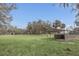 Metal carport on a beautiful lawn surrounded by trees at 255 Butterfly Forest Rd, Geneva, FL 32732