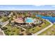 Stunning aerial view showcasing the community pool, clubhouse, and surrounding lake with lush landscaping at 2890 Avian Loop, Kissimmee, FL 34741