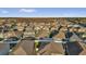 Neighborhood aerial view showcasing a community with fenced backyards and lush trees at 2890 Avian Loop, Kissimmee, FL 34741