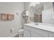 Clean bathroom features a white vanity, modern sink, framed mirror, and a walk-in shower with glass doors at 2890 Avian Loop, Kissimmee, FL 34741