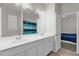 Well-lit bathroom features double sinks and a shower/tub combo behind a blue and green striped curtain at 2890 Avian Loop, Kissimmee, FL 34741