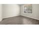 Comfortable bedroom featuring wood-look floors and a large window with blinds at 2890 Avian Loop, Kissimmee, FL 34741