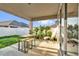 Inviting covered patio with outdoor furniture, string lights, and views of the fenced backyard at 2890 Avian Loop, Kissimmee, FL 34741
