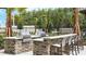 Outdoor grilling area with stainless steel grills, stone counters, and bar seating for community gatherings at 2890 Avian Loop, Kissimmee, FL 34741