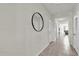 Neutral hallway featuring a large decorative mirror and easy access to other rooms in the home at 2890 Avian Loop, Kissimmee, FL 34741