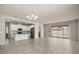 Open-concept living space with tiled floors, connecting the kitchen and dining area with sliding door access to the backyard at 2890 Avian Loop, Kissimmee, FL 34741