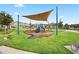 Community playground with a shaded play structure set in a well-maintained grassy area for children to enjoy at 2890 Avian Loop, Kissimmee, FL 34741