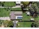 Aerial view showcasing the property's layout with a pool, green lawn, and surrounding foliage at 290 Orange Ave, St Cloud, FL 34769