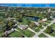 An aerial view of the community showing the home and neighborhood pond at 290 Orange Ave, St Cloud, FL 34769