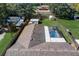 Aerial view of a home with a screened pool and a large, green backyard surrounded by trees at 290 Orange Ave, St Cloud, FL 34769