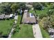 An aerial view showcasing a well-maintained lot with a screen-enclosed pool and long driveway at 290 Orange Ave, St Cloud, FL 34769