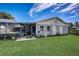 Backyard featuring a screened pool enclosure and green lawn at 290 Orange Ave, St Cloud, FL 34769