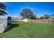 Spacious backyard with a shed, well-maintained lawn, and privacy fencing at 290 Orange Ave, St Cloud, FL 34769