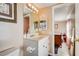 Well-lit bathroom featuring a vanity with sink and views to the adjacent bedroom at 290 Orange Ave, St Cloud, FL 34769