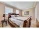 Bedroom featuring a wooden bed frame, tiled floors, and natural light from the windows at 290 Orange Ave, St Cloud, FL 34769