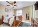 Comfortable bedroom with tile flooring, ceiling fan, and natural light from the window at 290 Orange Ave, St Cloud, FL 34769