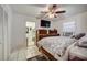 Bedroom with tile flooring, ceiling fan, and access to an ensuite bathroom at 290 Orange Ave, St Cloud, FL 34769