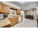Traditional kitchen featuring wood cabinets, stainless steel appliances, and tile flooring at 290 Orange Ave, St Cloud, FL 34769