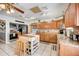 Bright, open kitchen featuring wood cabinetry, an island, and stainless steel appliances for modern convenience at 290 Orange Ave, St Cloud, FL 34769