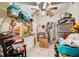 Cluttered room with tile floors and lots of storage items; great potential for organizing at 290 Orange Ave, St Cloud, FL 34769