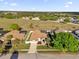 Aerial view of a single-Gathering home with lush landscaping and a well-manicured lawn at 3012 Samosa Hill Cir, Clermont, FL 34714