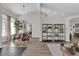 Bright dining room with modern chandelier, round table, and stylish black metal shelving at 3012 Samosa Hill Cir, Clermont, FL 34714