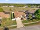 Beautiful single-story home featuring a well-manicured lawn, mature palm trees, and a welcoming two-car garage at 3012 Samosa Hill Cir, Clermont, FL 34714