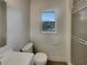 Clean bathroom with white fixtures, a shower with glass door, and a window, offering a bright and functional space at 38 Emerald Ct, Ocala, FL 34472