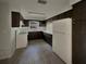 Well-lit kitchen with dark wood cabinetry and modern white appliances at 38 Emerald Ct, Ocala, FL 34472