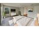 Bright main bedroom featuring sleek furnishings, a flatscreen TV, a ceiling fan, and wood-look floors at 38 Emerald Ct, Ocala, FL 34472