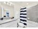 Full bathroom with shower and tub combo and striped curtain with granite vanity at 3811 Lana Ave, Davenport, FL 33897