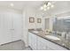 Bright bathroom showcasing a double sink vanity with granite counters and a glass-enclosed shower at 3811 Lana Ave, Davenport, FL 33897