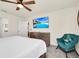 Cozy bedroom featuring a ceiling fan, mounted TV, accent chair, and decorative dresser at 3811 Lana Ave, Davenport, FL 33897