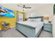Bright bedroom featuring a statement wall, ceiling fan, and comfortable furnishings at 3811 Lana Ave, Davenport, FL 33897