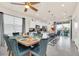 Open dining area with modern table setting, kitchen with island and stainless steel appliances at 3811 Lana Ave, Davenport, FL 33897